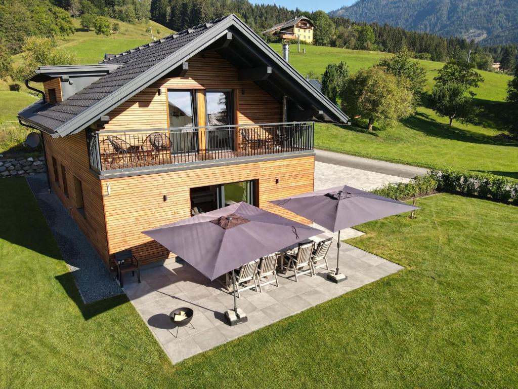 an overhead view of a house with tables and umbrellas at Luxury Chalet Mauthner Alm in Kötschach