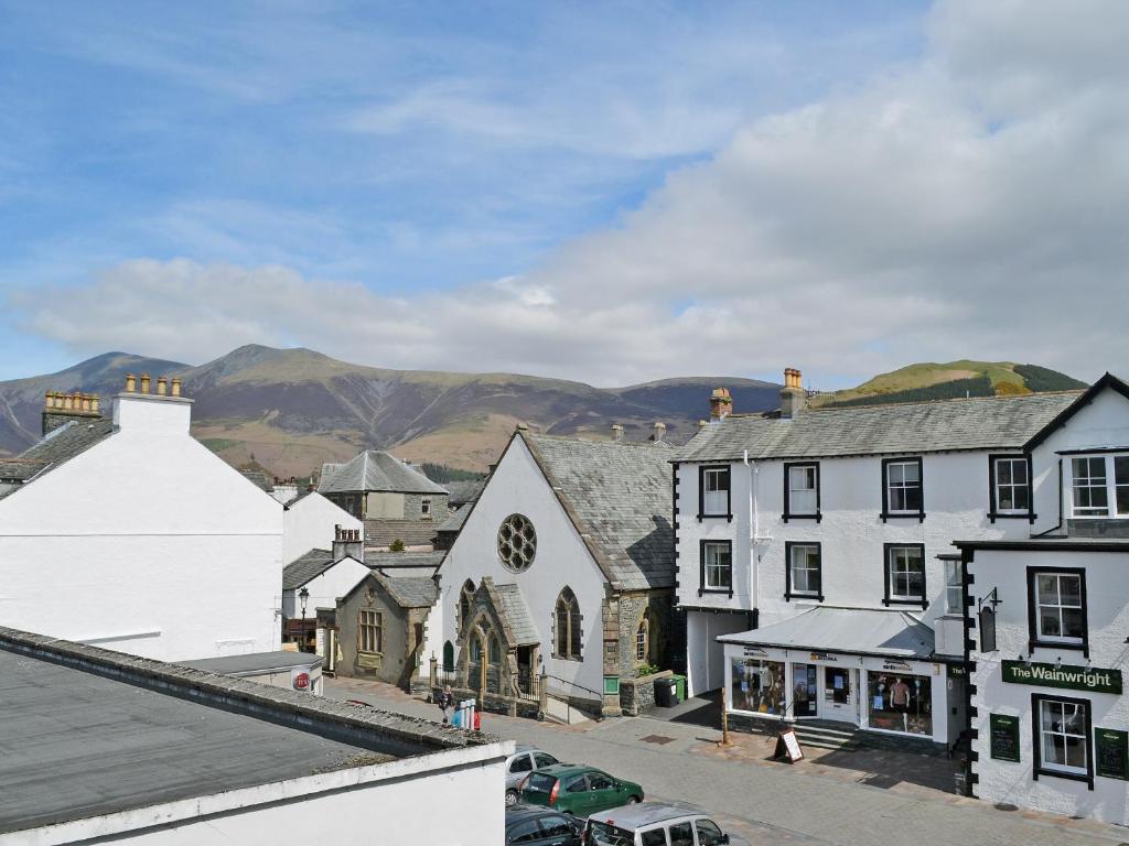 a town with buildings and mountains in the background at 5 Balmoral House in Keswick