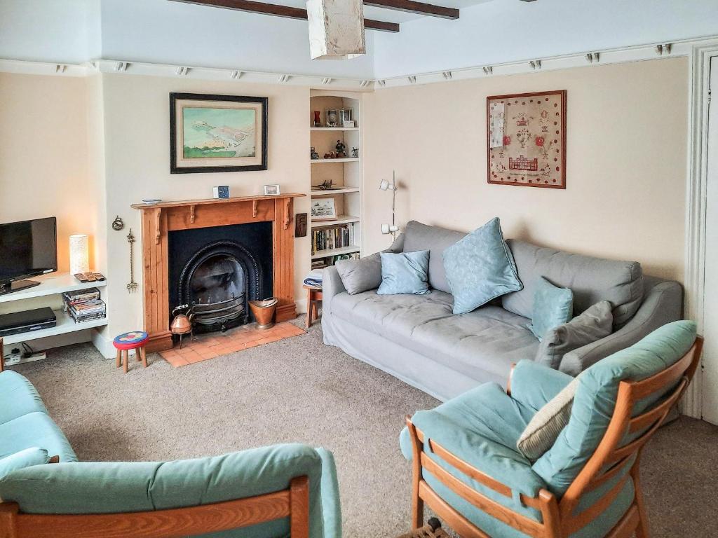 a living room with a couch and a fireplace at Coastguard Cottage in Fleetwood