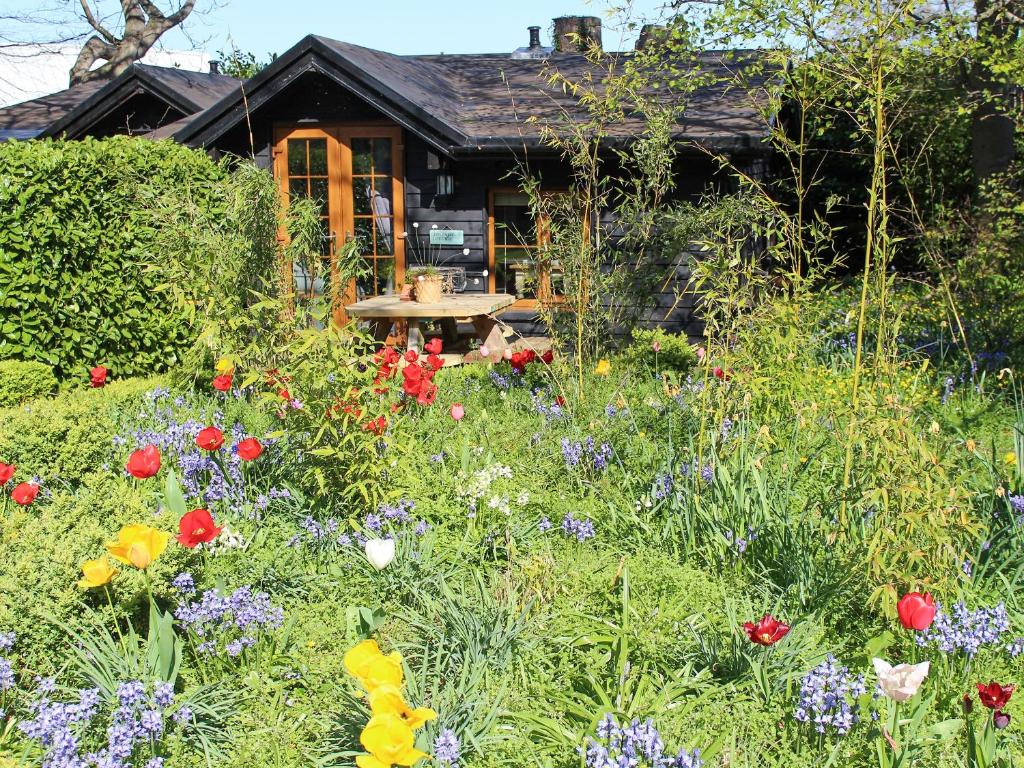 a garden with flowers in front of a house at Bluebell Cottage - 27635 in Darenth