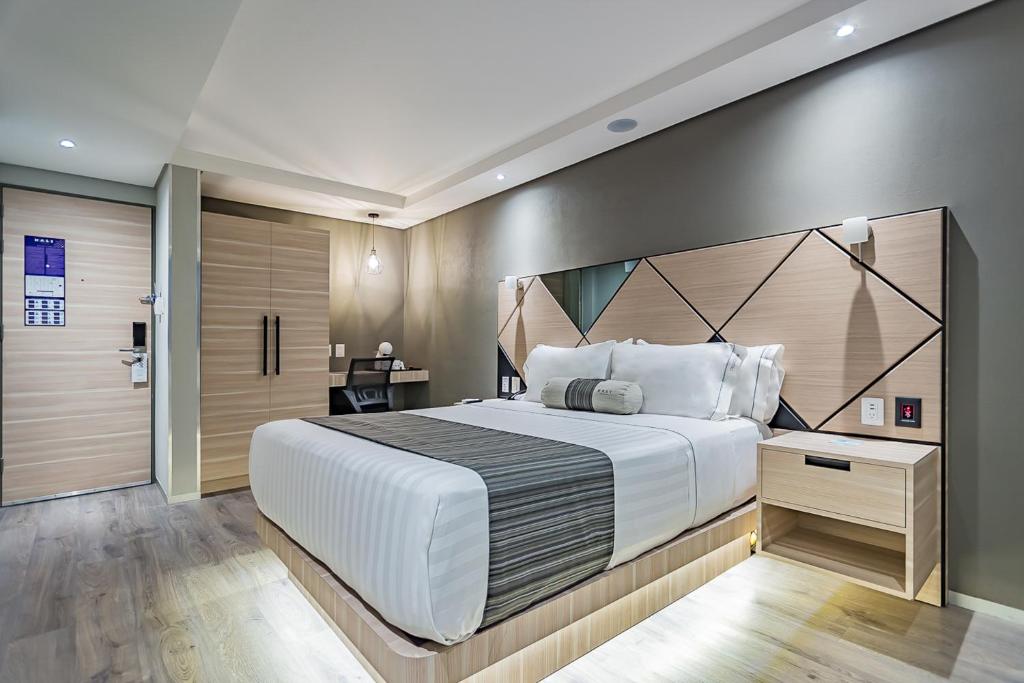 Postel nebo postele na pokoji v ubytování Kali Centro Mexico City