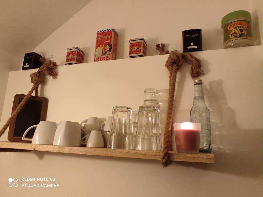 a shelf with jars and bottles on a wall at logement Mezzanine salon indépendant in Mézières-sur-Seine