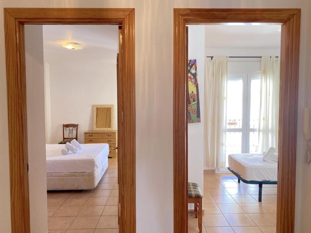 Postel nebo postele na pokoji v ubytování Milenio 1H Apartments Casasol