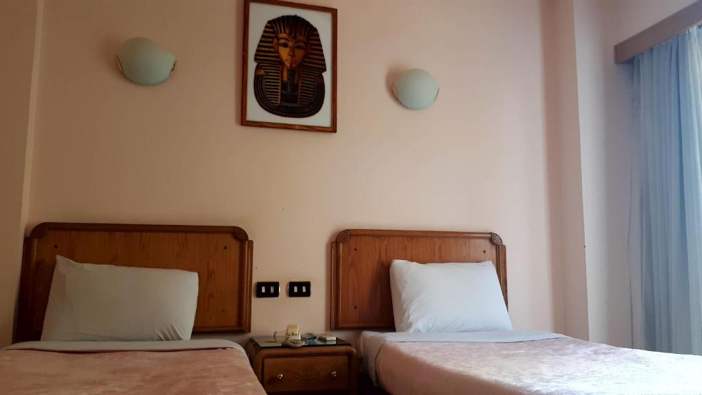 Postel nebo postele na pokoji v ubytování New Pola Hotel
