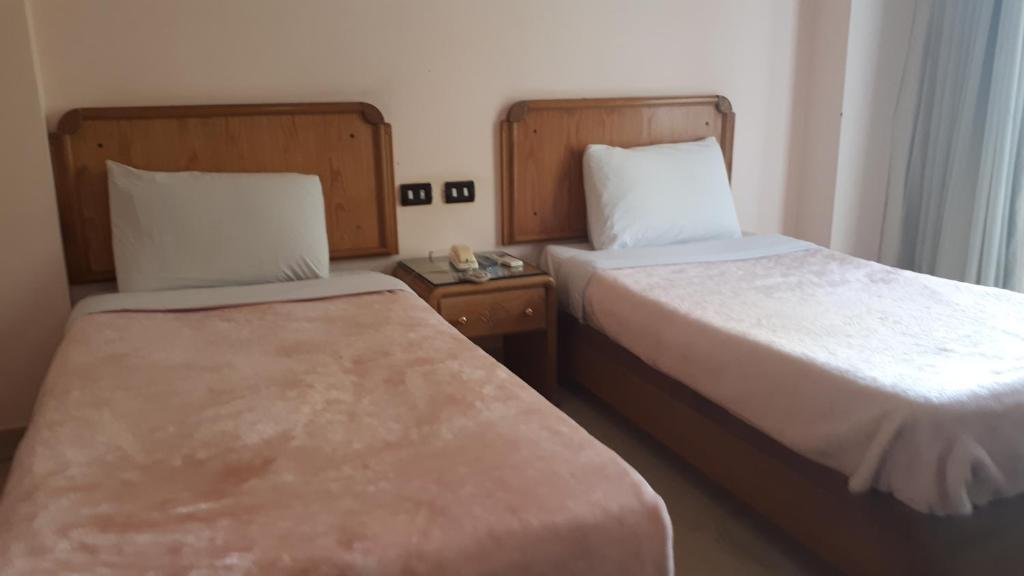Postel nebo postele na pokoji v ubytování New Pola Hotel