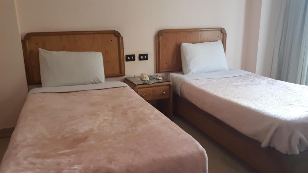 Postel nebo postele na pokoji v ubytování New Pola Hotel