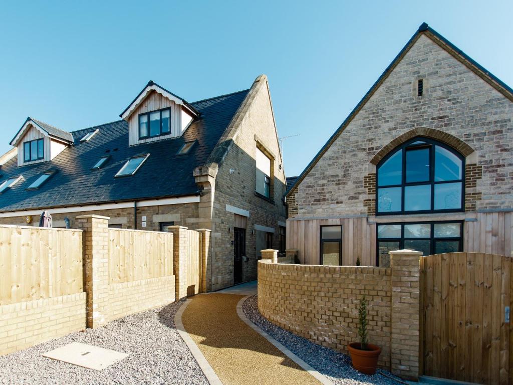 a brick house with a wooden fence in front of it at 8 Old School Mews in Shanklin