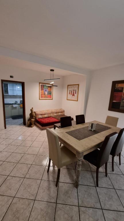 a living room with a table and chairs and a couch at SWEET HOME in Azzano San Paolo