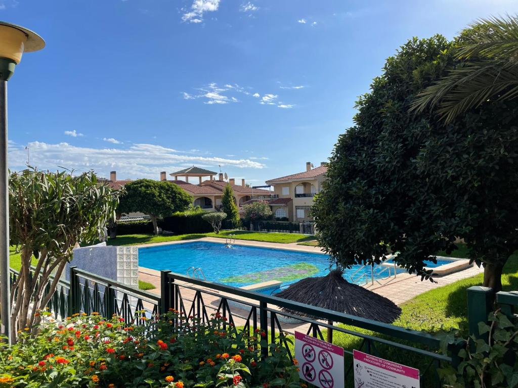 a view of a swimming pool in a yard at Modern Apartman - Novamar 1 in Gran Alacant