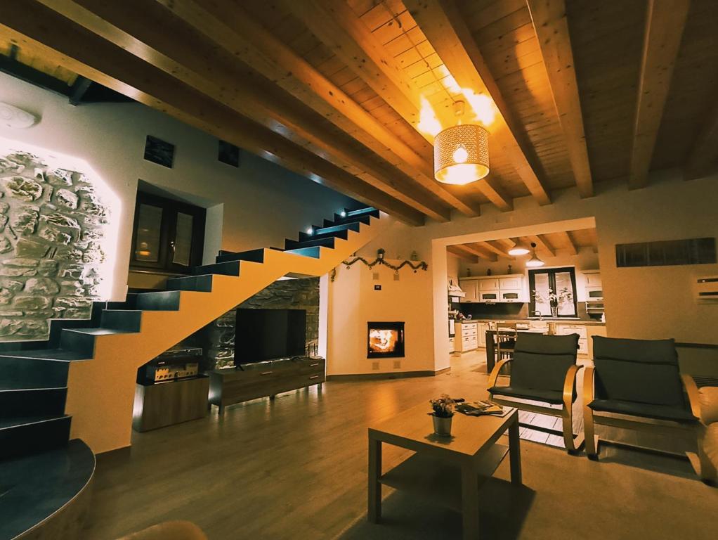 a living room with a staircase leading up to a fireplace at Casa del Sole in Polizzi Generosa