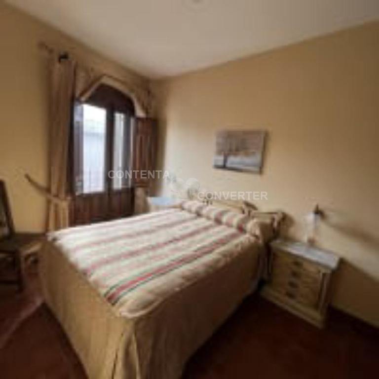 A bed or beds in a room at Apartamentos Turísticos La Posada