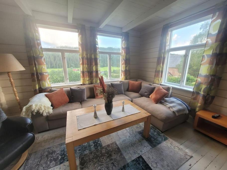 a living room with a couch and a coffee table at Skogan in Leirfjord