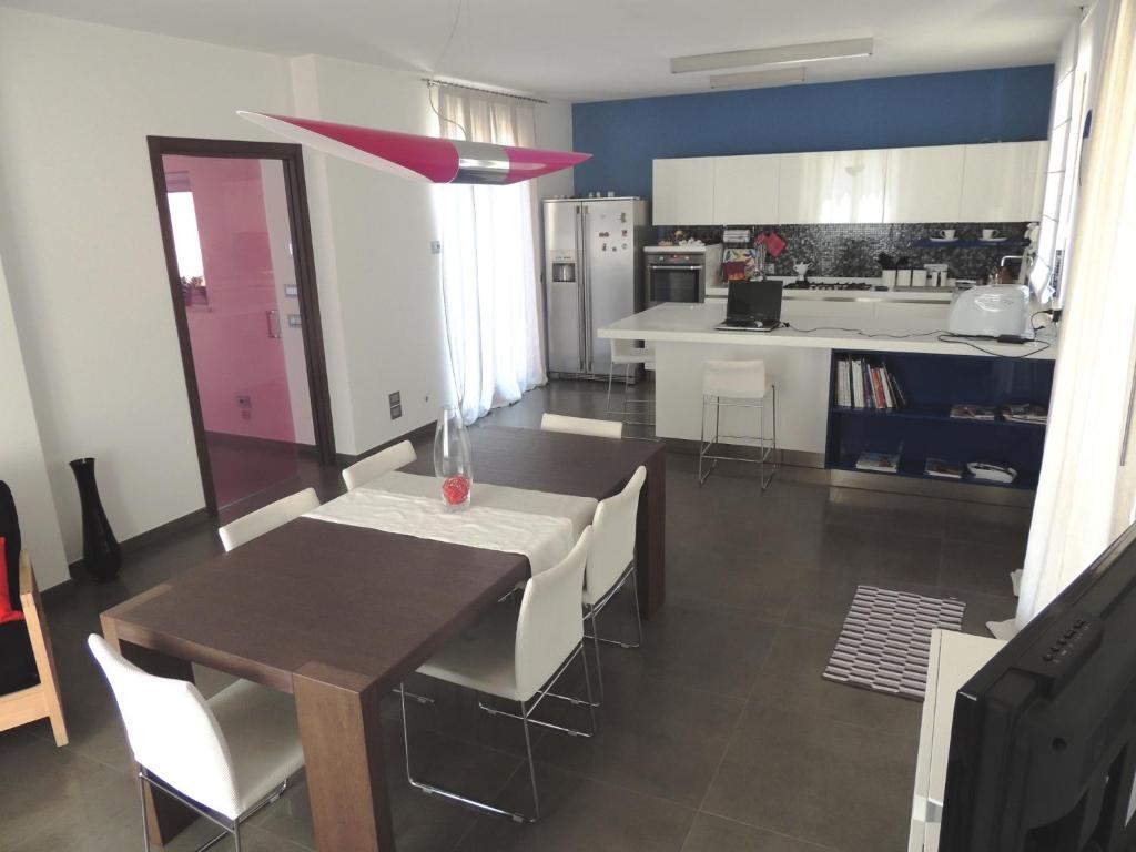 a kitchen and dining room with a table and chairs at Ross House in Fermo