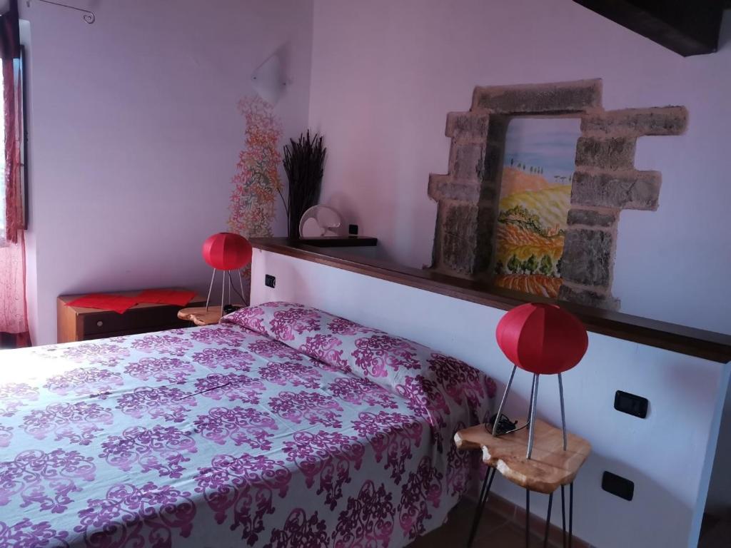 a bedroom with a bed and a mirror on the wall at Cà Feddia in Bagnone