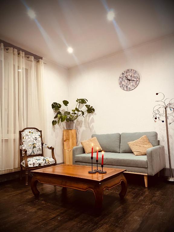 a living room with a couch and a table with candles at Petit prince chambre à louer in Saint Die