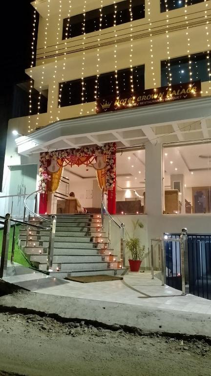 a building with stairs in front of a building with lights at Hotel Crown Palace in Patna