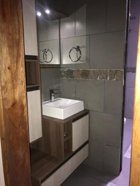 a bathroom with a white sink and a mirror at Costera sur in Garupá