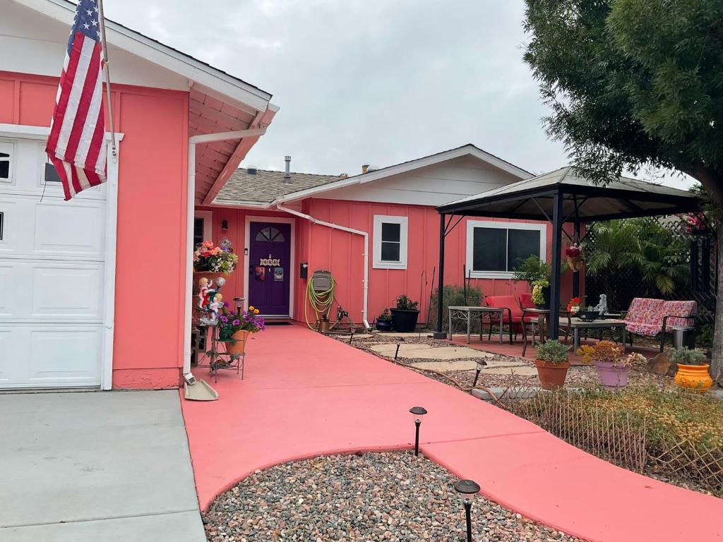 una casa roja con una bandera en una entrada roja en The Rose Inn, en Santee
