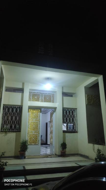 a white house with a light on the front of it at Villa familys in Fez