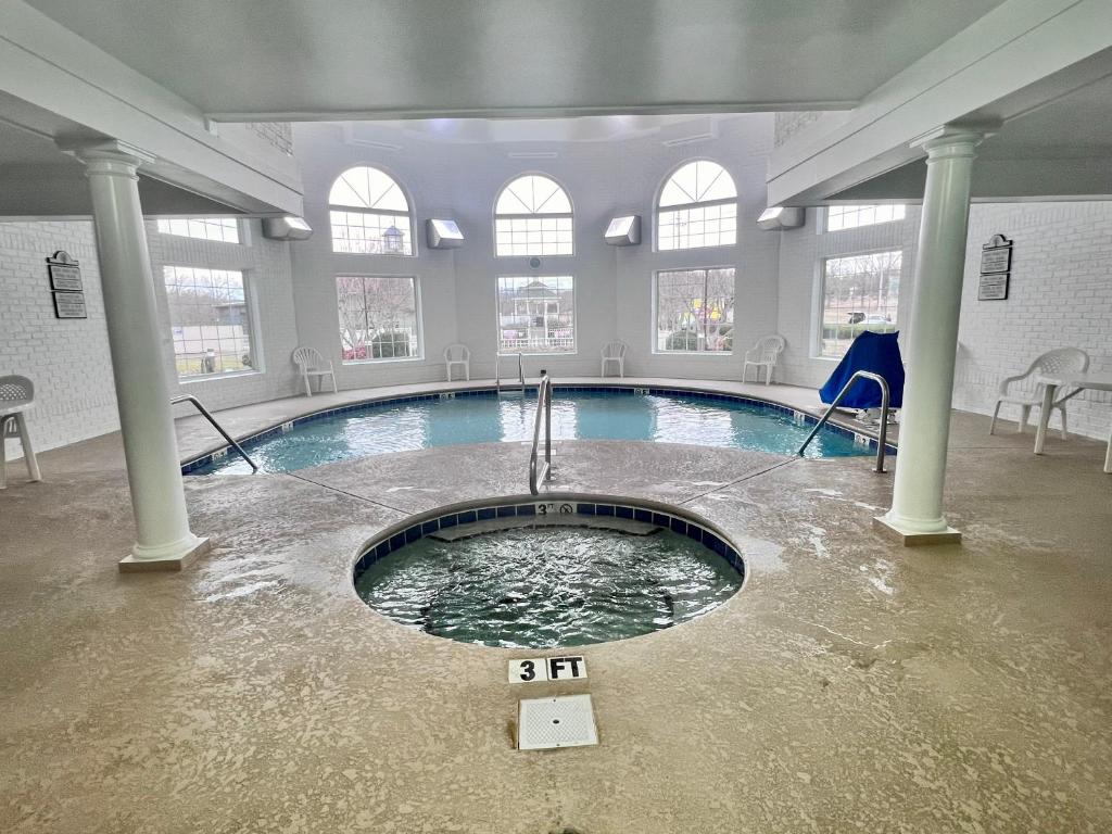 a swimming pool in a building with water in it at Clarion Inn Willow River in Sevierville