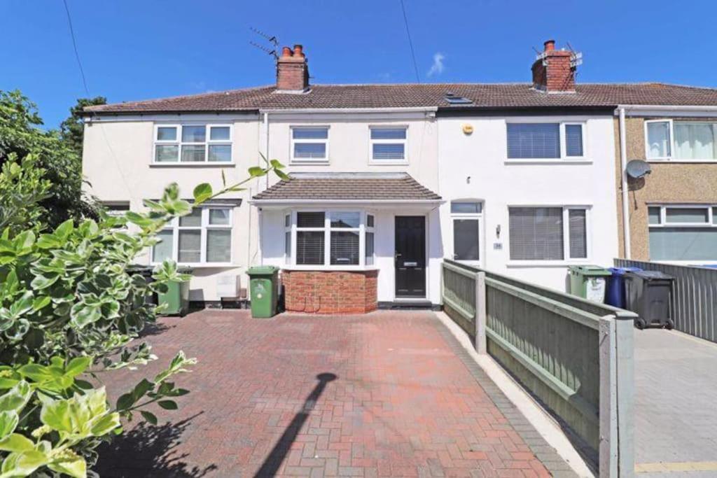 a large white house with a brick driveway at Cheerful 2 bedroom holiday home with parking in Cleethorpes
