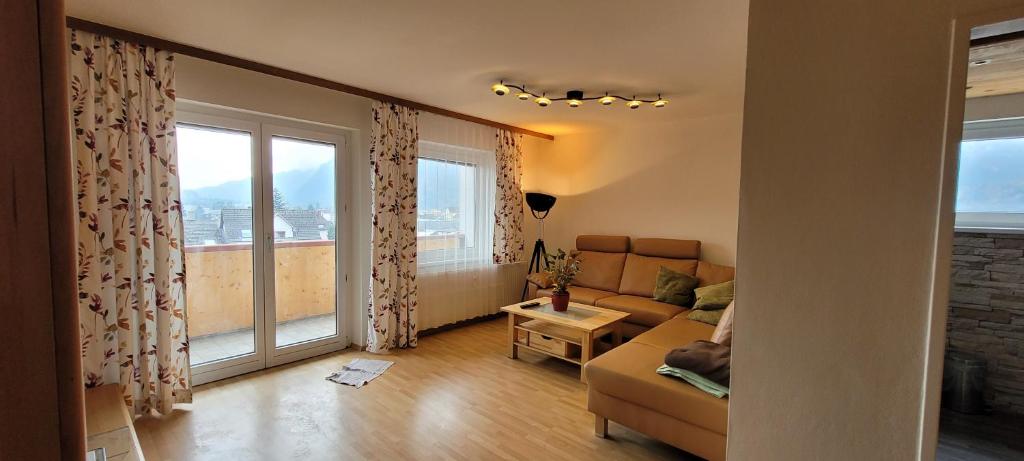 uma sala de estar com um sofá e uma grande janela em Alpen Appart Bludenz City em Bludenz