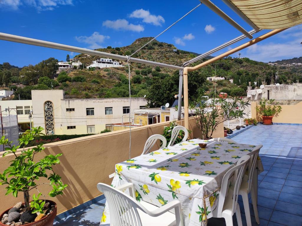 a table and chairs on a balcony with a view at Attico in centro con vista mare e monti! in Marina