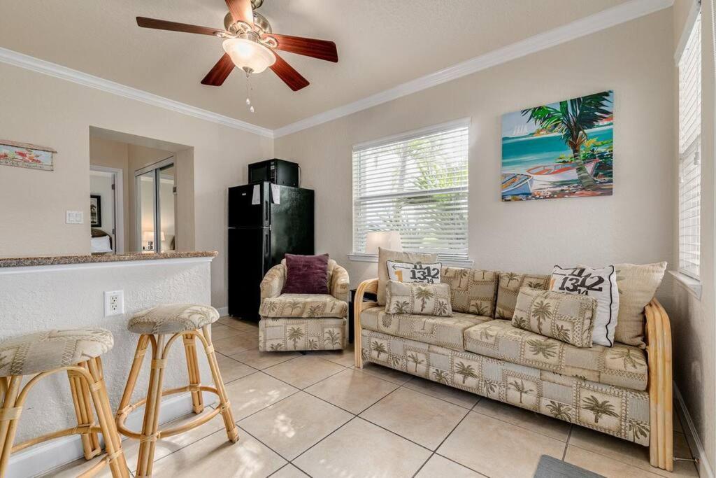 a living room with a couch and a ceiling fan at Steps to the Beach and Restaurants! - Coconut Villa's Suite 1 in St. Pete Beach