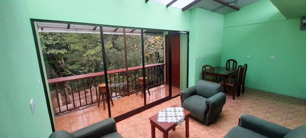 a living room with a large window and a couch at La casa de tia in Monteverde Costa Rica
