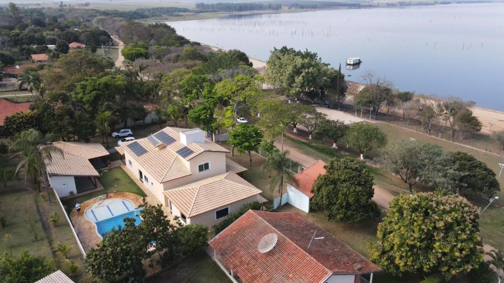an aerial view of a house next to the water at Chácara/ Rancho Família Campos in Bicanca