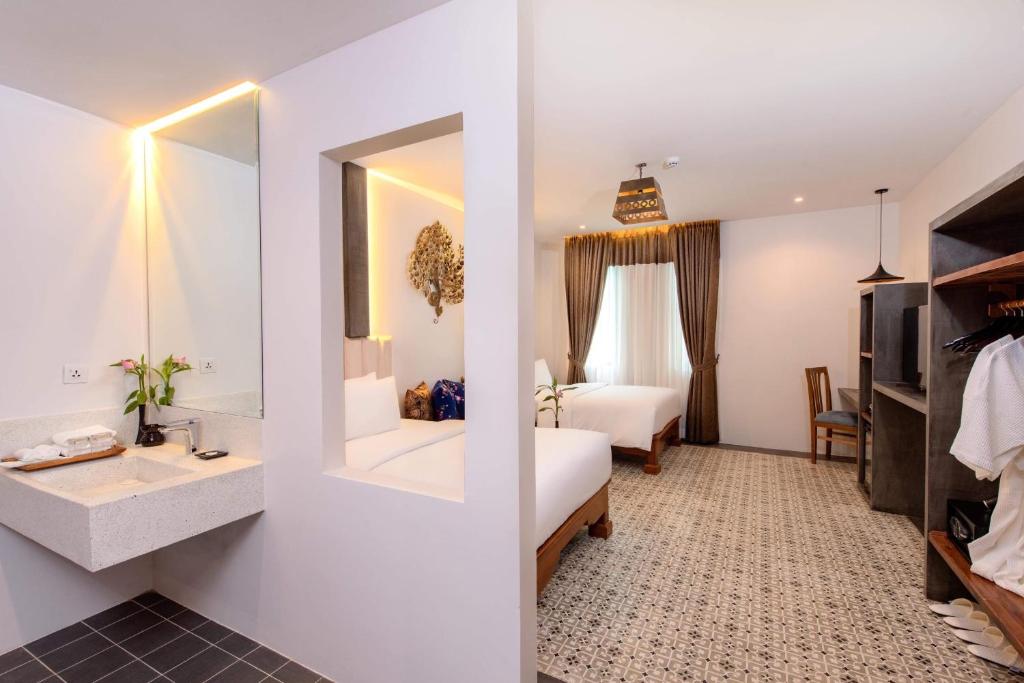 Postel nebo postele na pokoji v ubytování Siem Reap Palace Hotel & Spa