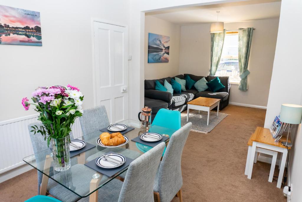sala de estar con mesa y sofá en Cheltenham-2 Bed House-Sleep 6-Parking-Garden-Wifi, en Cheltenham