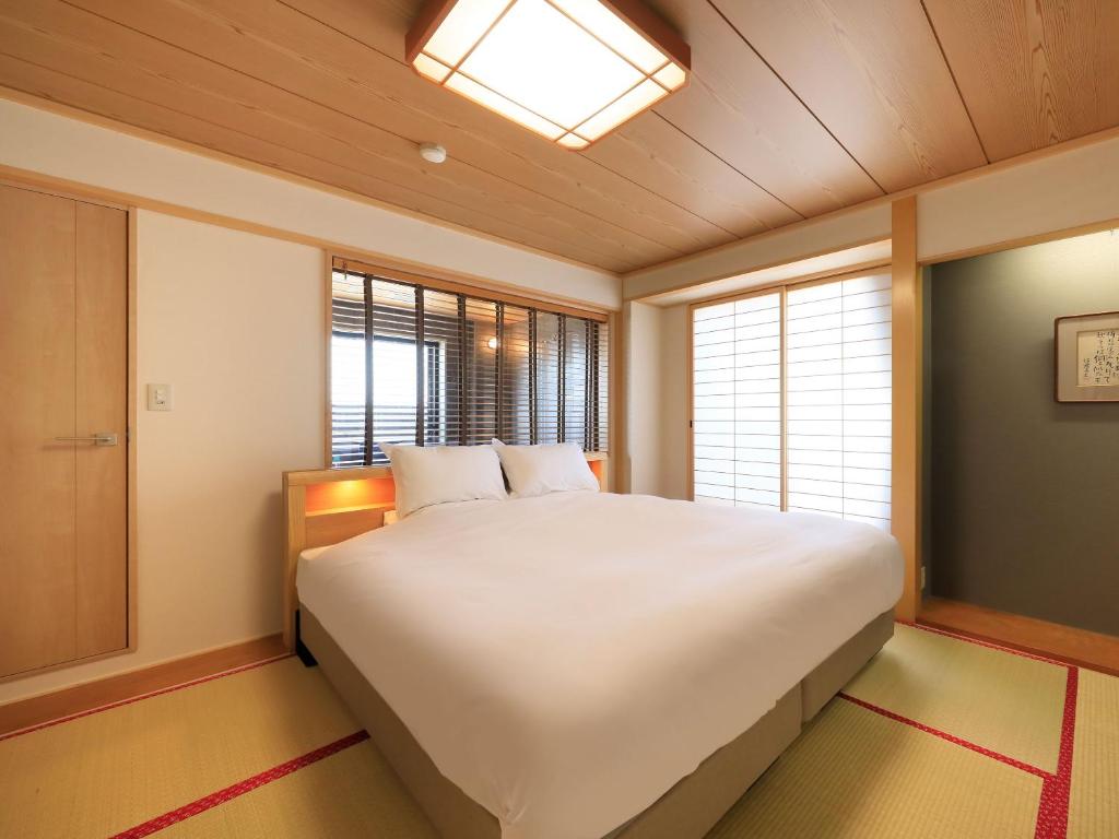 Postel nebo postele na pokoji v ubytování Hotel Tsubakino