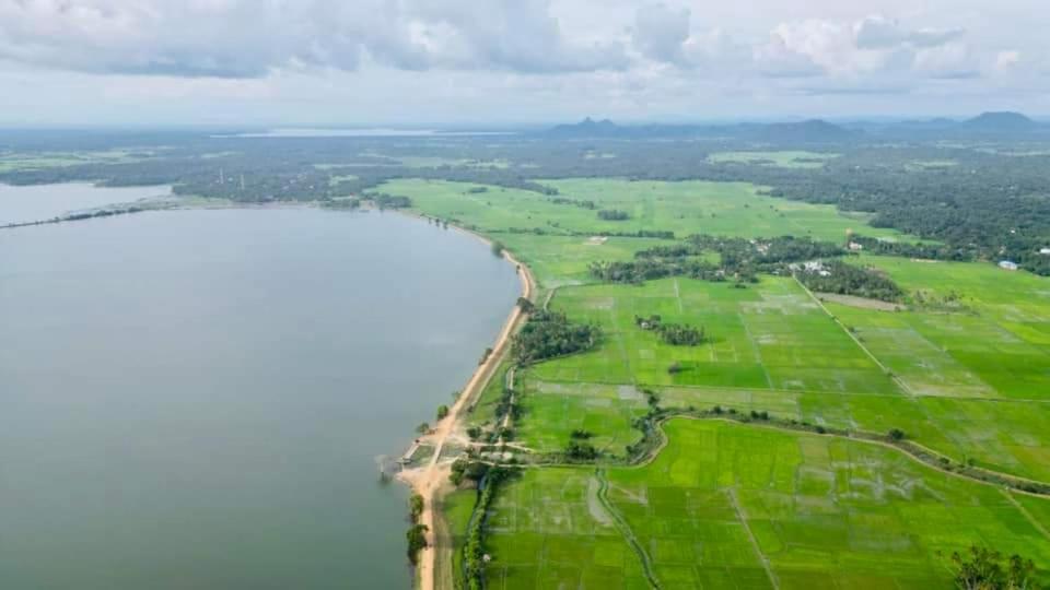 an aerial view of the shoreline of a lake at Green Lake in Tissamaharama