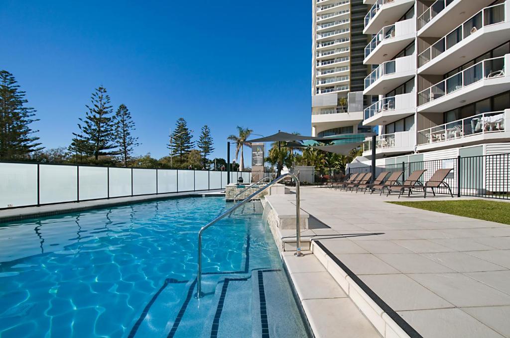 a swimming pool in front of a building at South Pacific Plaza - Official in Gold Coast