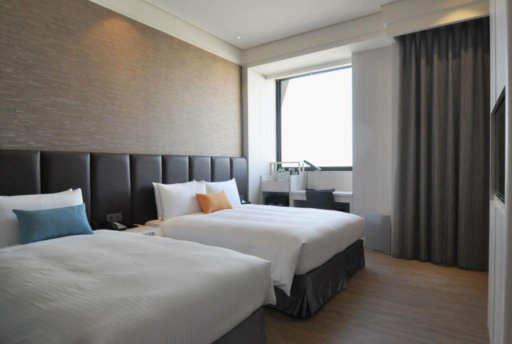 Postel nebo postele na pokoji v ubytování Treeart Hotel