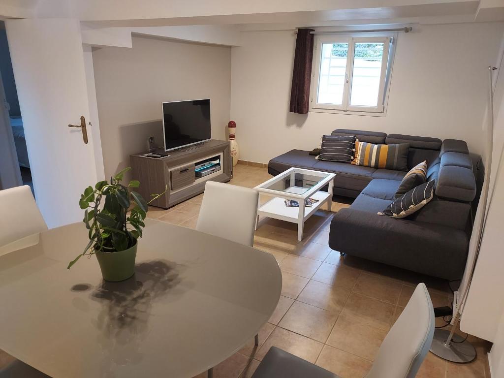 a living room with a table and a couch at Cosy Appartement near Disneyland & Paris in Coupvray