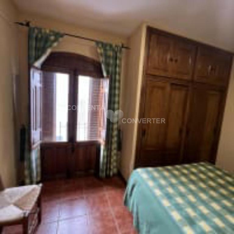 A bed or beds in a room at Apartamentos Turísticos La Posada