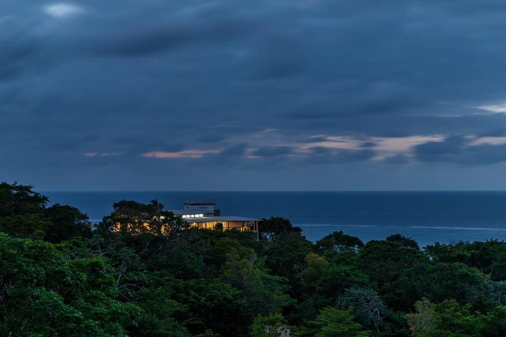 a house on top of a hill with trees at VILLA ROA in Roatán