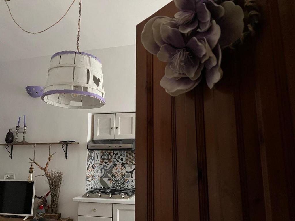 a door in a kitchen with a light and a lamp at fuga sui sibillini in Gualdo di Macerata