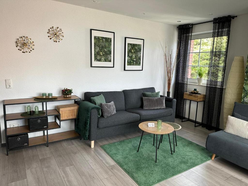 a living room with a couch and a table at Apartment nahe Naturschutzgebiet „Wurmtal“ in Würselen