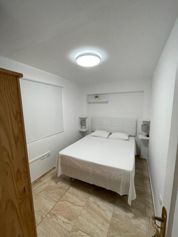 A bed or beds in a room at Apartamentos Elena
