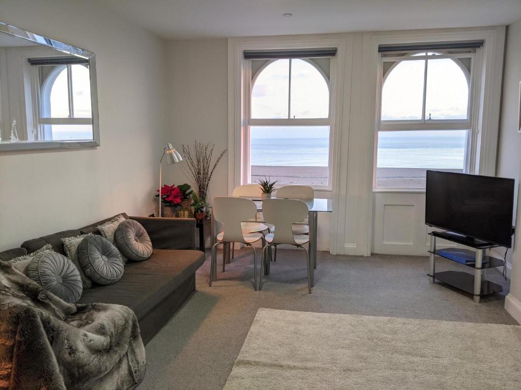 a living room with a couch and a table at 3BD Coastal Retreat with Spectacular Sea Views in Folkestone