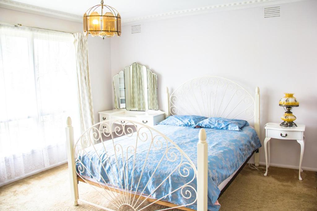 a bedroom with a blue and white bed with a window at 带浴室和步入式衣柜的舒适主卧Master bedroom with Shower room in Forest Hill