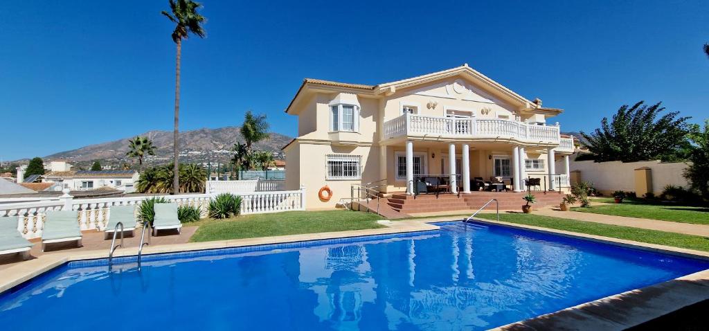 a large house with a swimming pool in front of it at Golden Villa Costa del Sol - Big Private Pool - BBQ - Good Location in Fuengirola