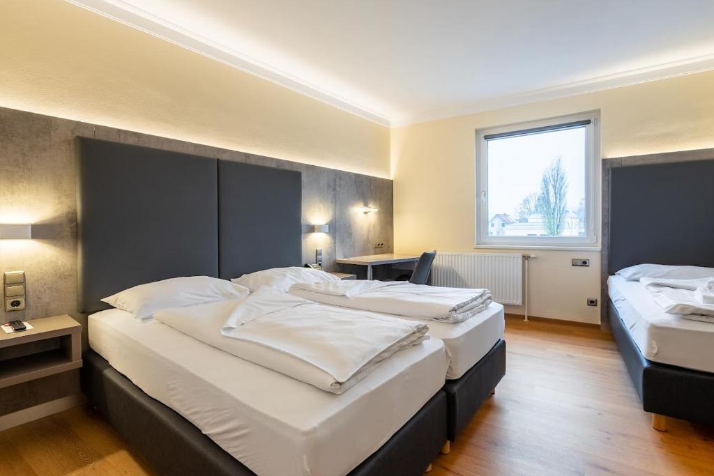 Posteľ alebo postele v izbe v ubytovaní Das Reinisch Just Rooms