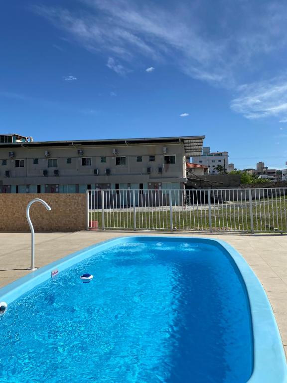 a large blue swimming pool on top of a building at Loft e Suites Temporada in Balneário Camboriú