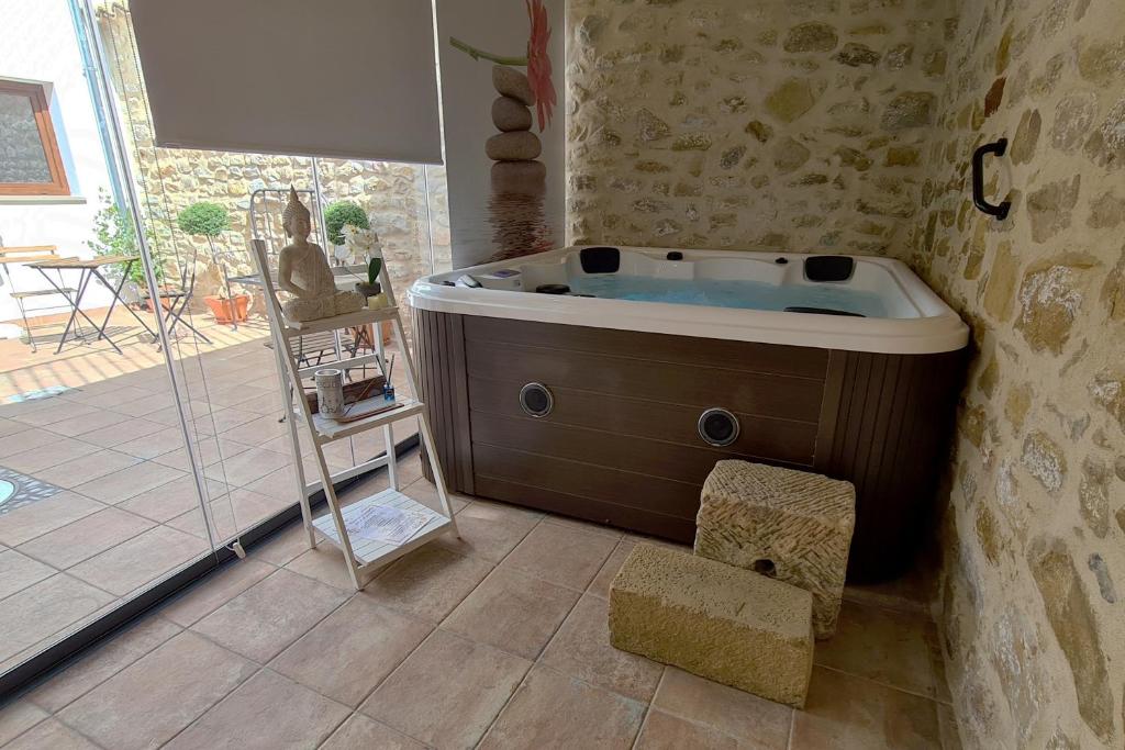 ein Bad mit einer Badewanne in einem Zimmer in der Unterkunft Apartamentos Turísticos El AOVE in Baeza