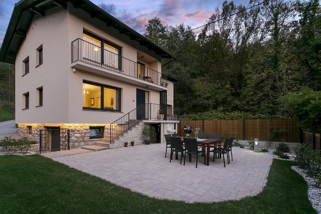 a patio with a table and chairs in front of a house at Angel Boutique Home - Entire premium house in Laško