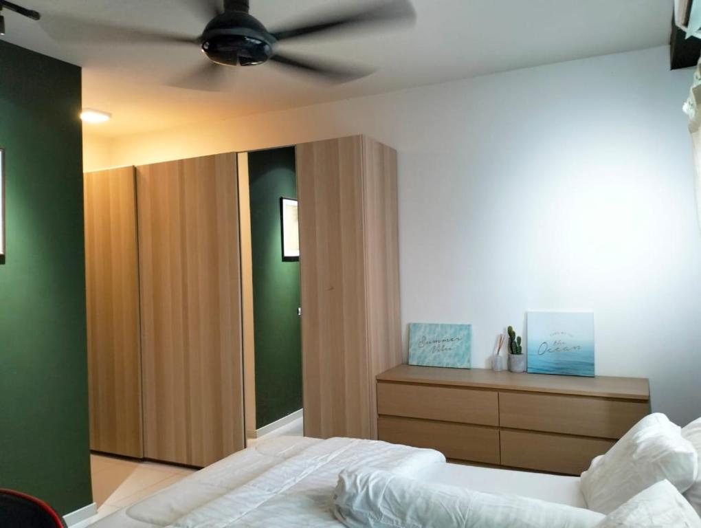 a bedroom with a bed with a ceiling fan at EMIRA RESIDENT in Shah Alam